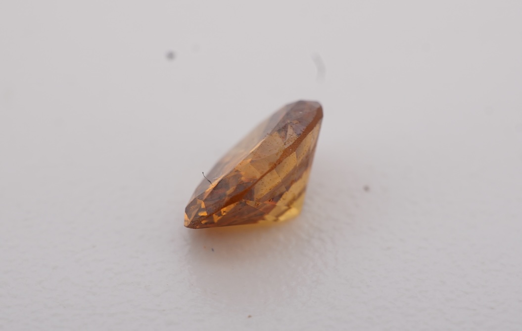 An unmounted Fancy Deep Brown-Orange diamond, the oval natural diamond measuring 5.3 x 3.9 x 2.5mm, with treated colour, weighing 0.34 carats, Accompanied by GIA report no. 6233434030, stating that the Fancy Deep Brown-O
